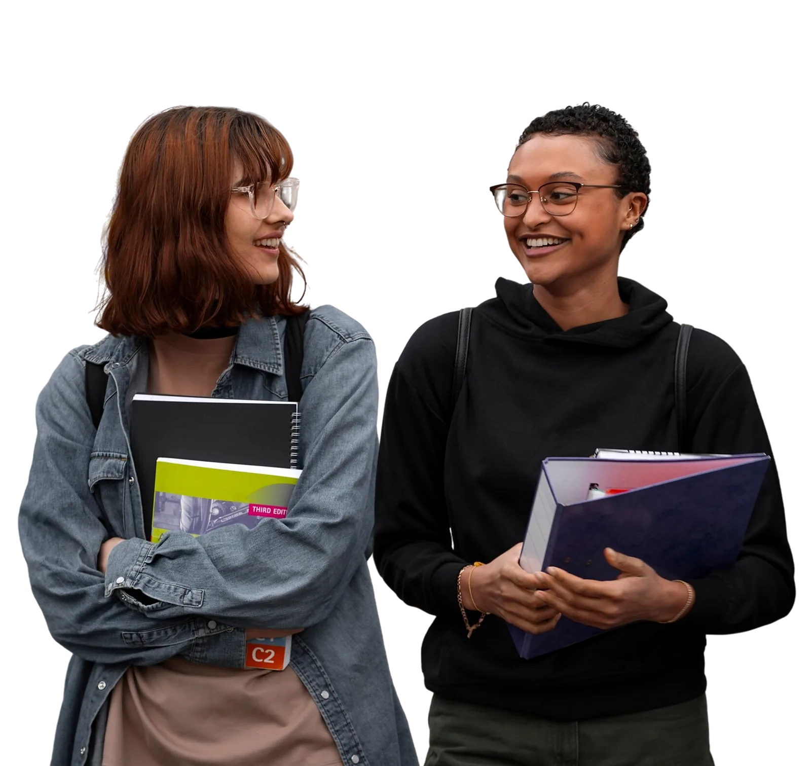 Developing Skills | CAQA LLND Two students discuss coursework while carrying books and folders during a developing skills program.