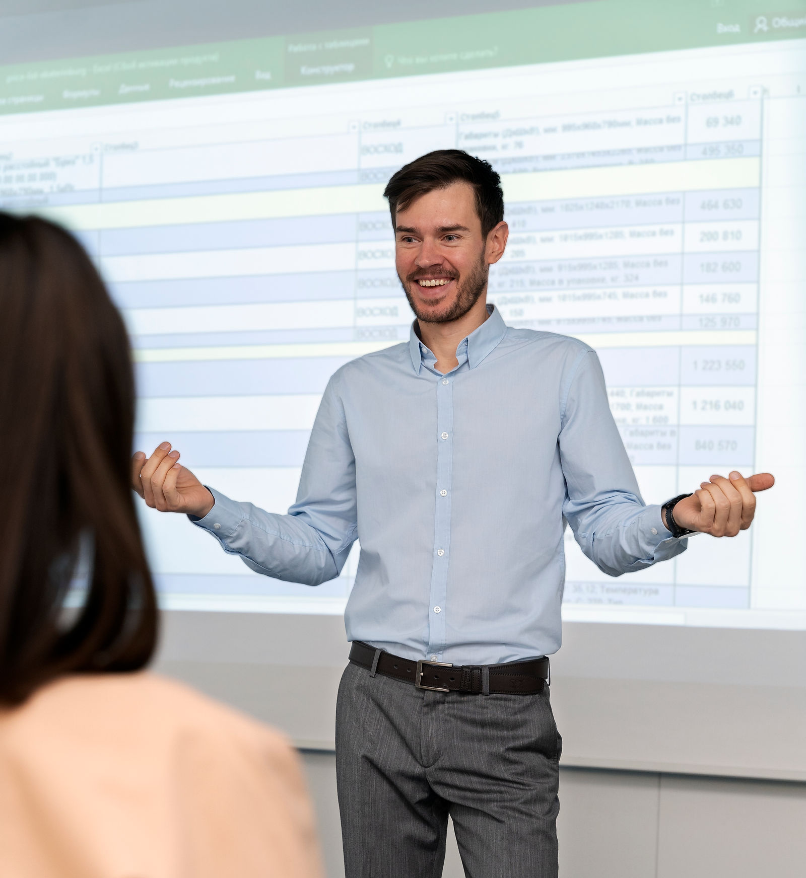 Office Worker | CAQA LLND A man presents data from a spreadsheet during an office meeting illustrating llnd training delivery.