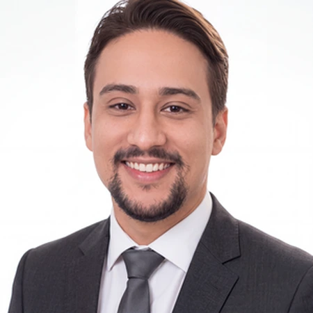 Abishek Timsina | CAQA LLND A smiling man in a suit and tie poses for a professional headshot of an LLND consultant.