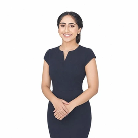 Jissimran Sandhu | CAQA LLND A woman in a dark dress smiles at the camera, representing our LLND team.