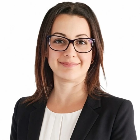 Michelle Newman | CAQA LLND A professional woman with brown hair and glasses smiles at the camera, representing CAQA LLND's literacy and numeracy.