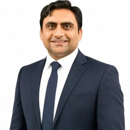 Sukh Sandhu | CAQA LLND A business professional, Sukh Sandhu, smiles for a headshot as part of the CAQA LLND team.