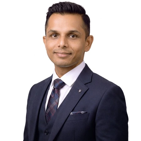 Vijay Patel | CAQA LLND A man in a suit and tie poses for a professional headshot of Vijay Patel, an LLND consultant.