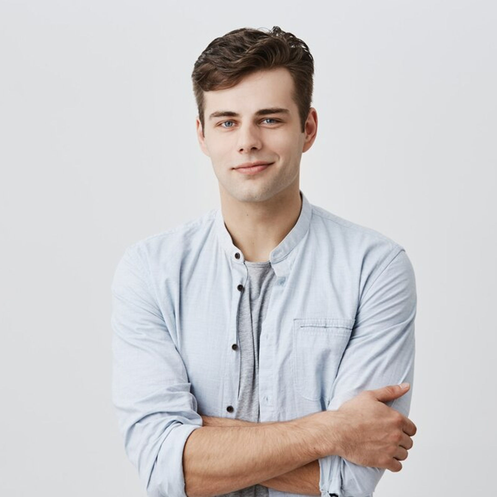 Young Man | CAQA LLND A young man with brown hair and blue eyes poses with crossed arms, representing employability skills training.