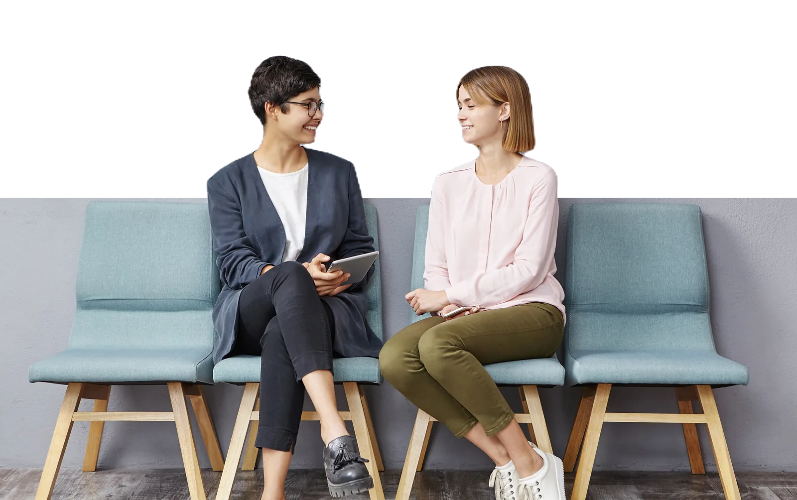Young Women | CAQA LLND Two women are having a conversation in a waiting room, demonstrating employability skills.